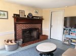 Living room with TV and working wood fireplace